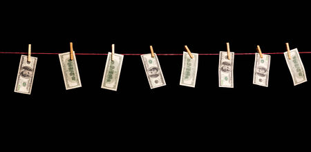 Dollars banknotes are hanging on a rope isolated on black
