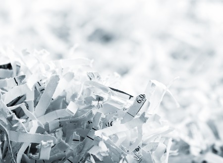 Closeup picture of big heap of white shredded papersの写真素材