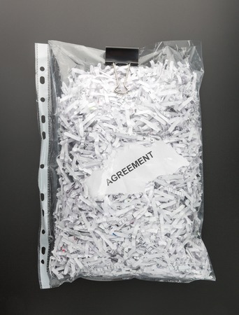 Shredded papers of agreement inside the fileの写真素材
