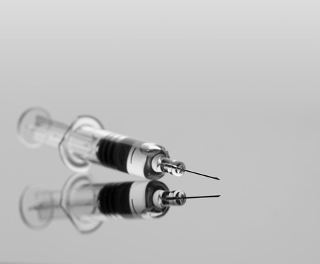 Medical syringe with vaccine on grey backgroundの写真素材