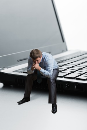 Office employee sitting on laptop thinksの写真素材