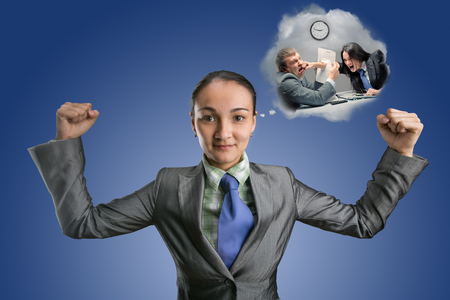 Strong business woman thinking about fighting on blue backgroundの写真素材