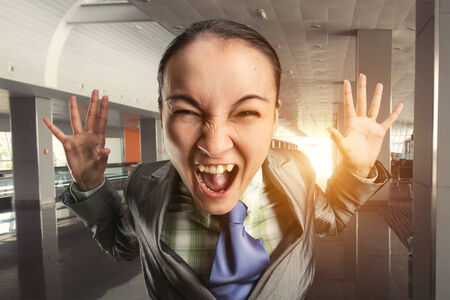 Shouting irritated woman in the officeの写真素材