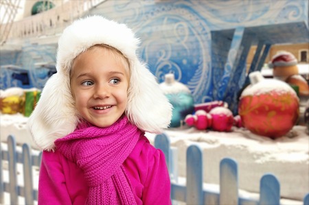 Small girl in hat in winter interior