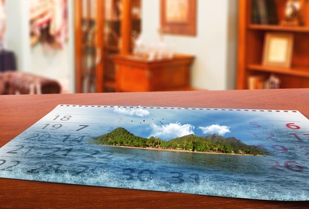 Calendar  with beautiful  landscape  lays on the tableの写真素材