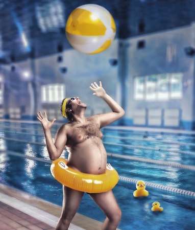 Adult man having fun in poolの写真素材