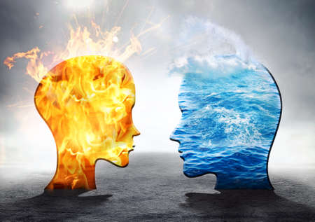 Silhouettes of man and woman, water and fireの写真素材