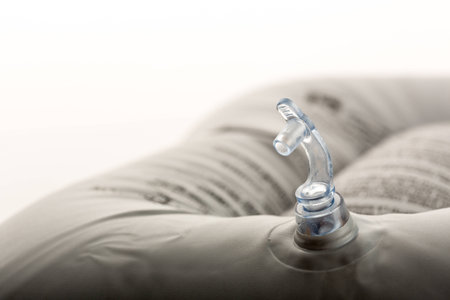 Inflatable bath cushion with open valve isolated on whiteの写真素材