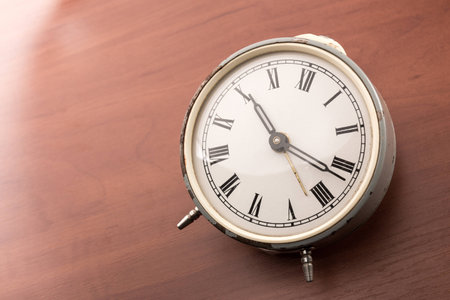 Alarm clock on the  woooden table