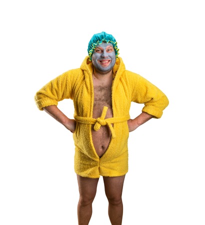 Crazy man with face pack in bathrobe isolated on whiteの写真素材