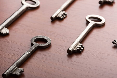 Macro of keys lie on the wooden tableの写真素材
