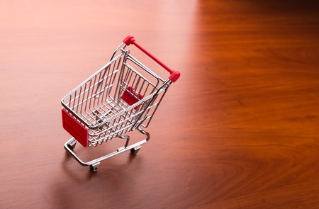Supermarket trolley on the wooden floorの写真素材