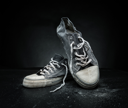Old sports trainers on the greyの写真素材