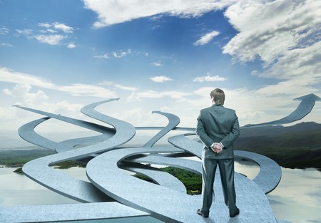 Businessman is choosing his way on nature backgroundの写真素材