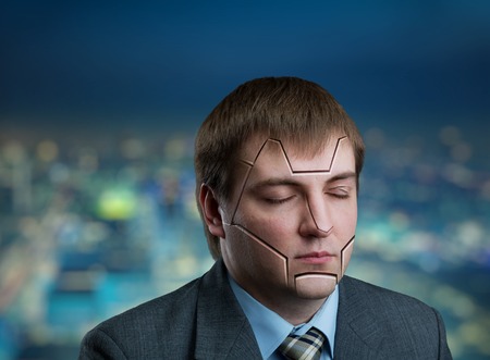 Businessman head with cracks on his face on city backgroundの写真素材