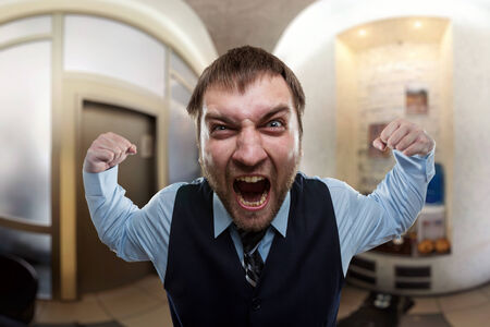 Businessman screaming at the officeの写真素材