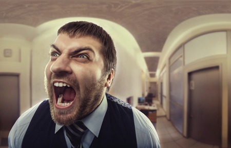 Crazy businessman shouting at officeの写真素材