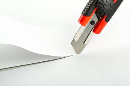 Macro of office knife cutting paper
