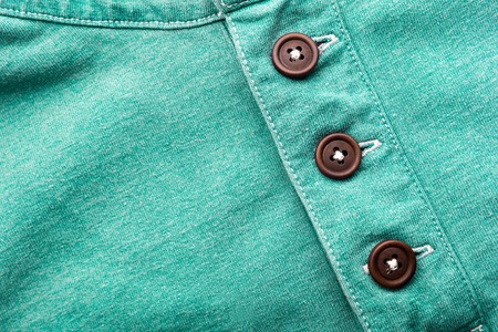 Closeup of green cloth with plastic buttonsの写真素材