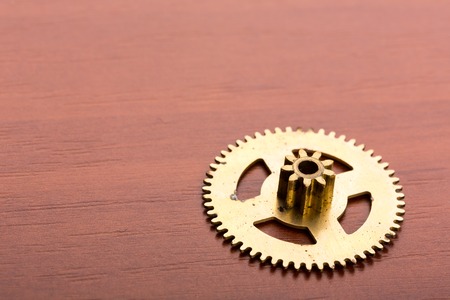 One clock gear on the wooden table