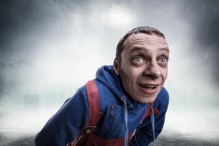 Surprised young man whith big eyes over greyの写真素材