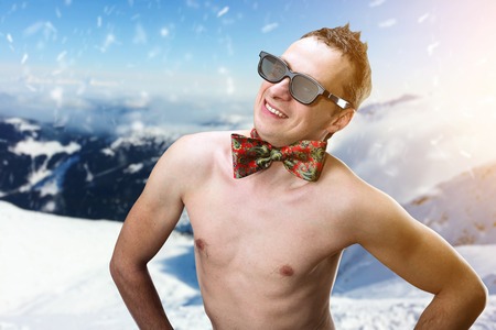 Hot summer naked man in winter mountainsの写真素材