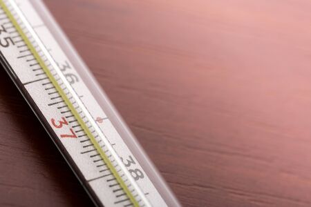 Thermometer on a wooden tableの写真素材