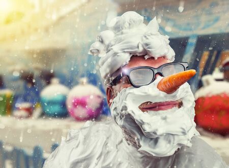 Strange smiling man with carrot nose and with shaving foam on his face