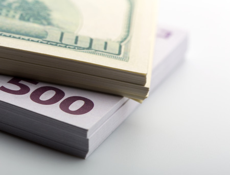 Packs of dollars and euros closeup
