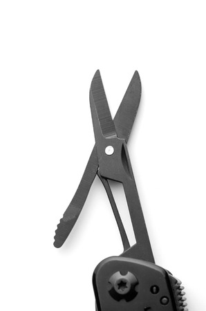 Black opened scissors on multitool knife isolated on white