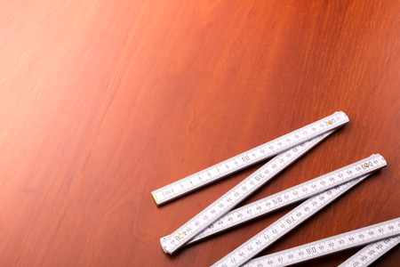 White measuring tepe on the wooden tableの写真素材