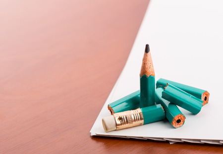 Broken pencil on the wooden tableの写真素材