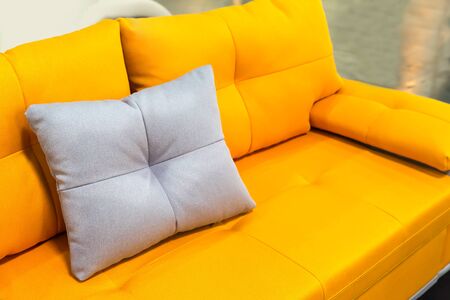 Yellow sofa with white pillowの写真素材