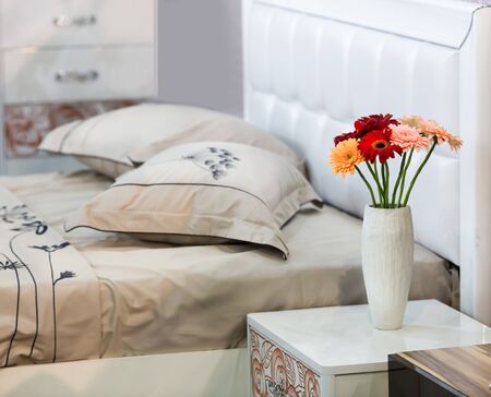 Bouquet of flowers stands on the table in the bedroomの写真素材