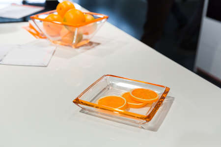 Few pieces of an orange on a glass plateの写真素材