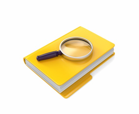 Magnifying glass lying on yellow folder isolated on whiteの写真素材