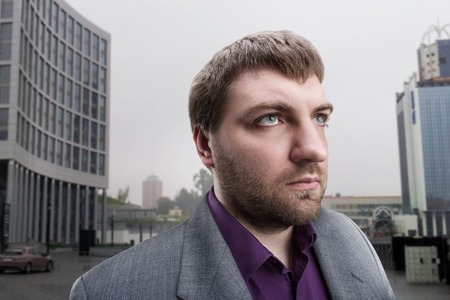 Serious businessman against the cityの写真素材