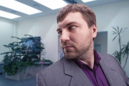 Businessman looking behind himself in the roomの写真素材