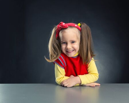 Cute little girl smiling over greyの写真素材