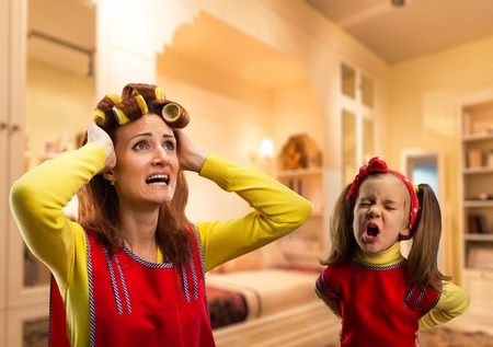 Angry little girl bawling at her mother at homeの写真素材