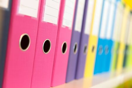 Number of folders standing on the shelf in the officeの写真素材