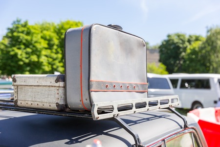 Old grey suitcases standing on the car topの写真素材
