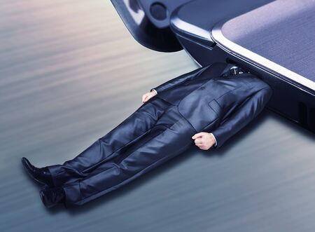 Man plugged into the laptop as a flash driveの写真素材