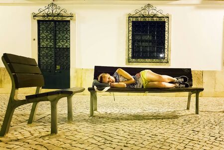 Woman sleeping on the streetの写真素材