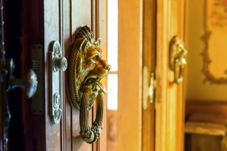 Close up of wooden doors with two metal knobsの写真素材