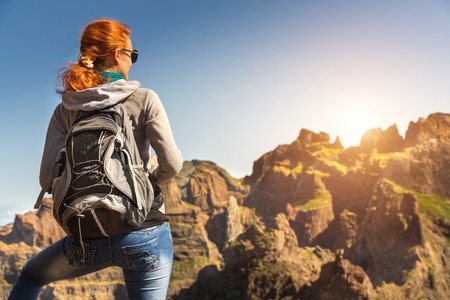 Young woman standing back with a backpack, Portugal, Madeiraの写真素材