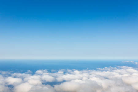Aerial view of clear sky above the clouds against oceanの写真素材