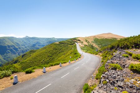 View of the road leading up in the green summer mountains, Portugal, Madeiraの写真素材