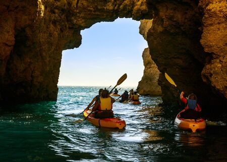 People are kayaking in the rocky tunnel in the sea, Portugalの写真素材