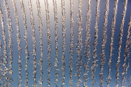 Water streams in the air against blue skyの写真素材